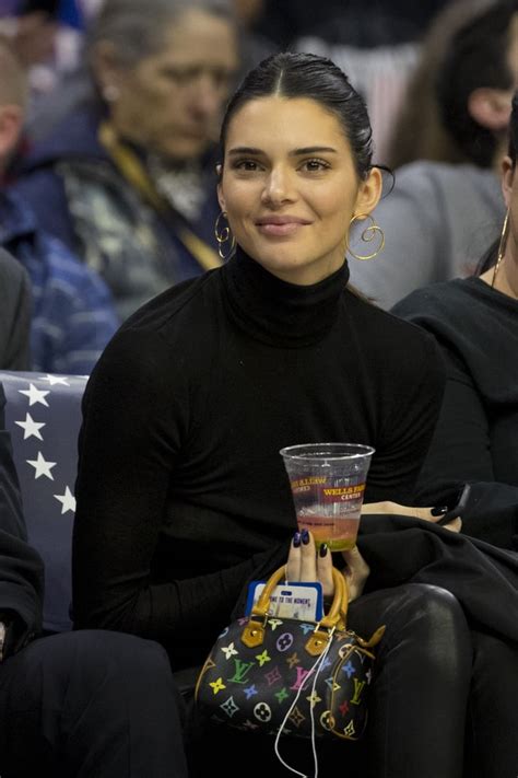 Kendall Jenner carries mini Louis Vuitton purse to basketball game